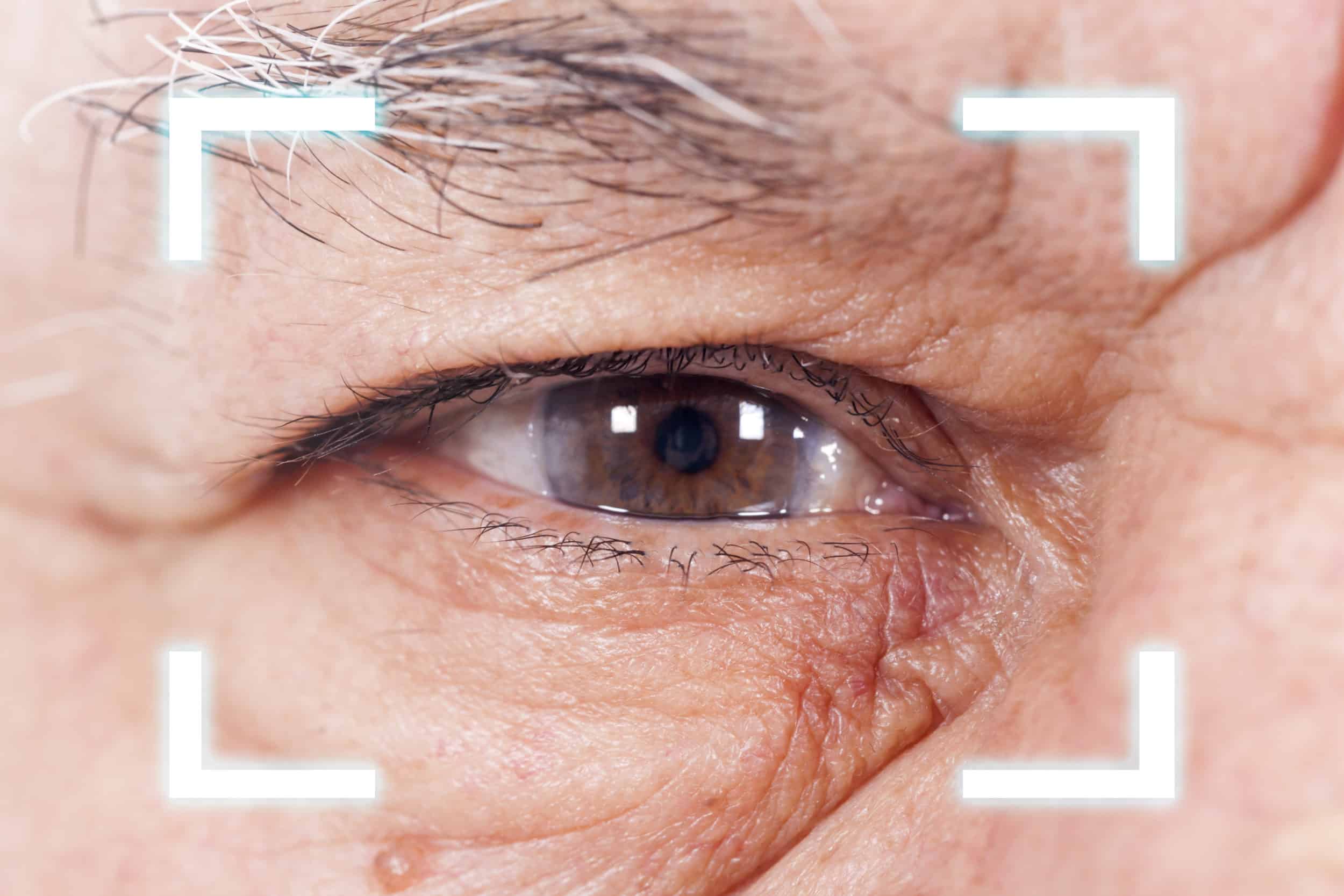 Close-up of Old Man's  eye. High Technologies in the future