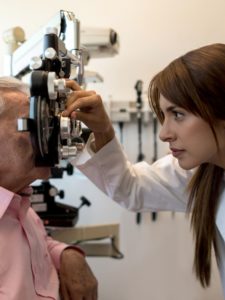 female optometrist using a phoropter on senior patient picture id955034092 225x300 1