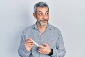 Middle-aged man tests his blood sugar. Eye doctors can help protect his vision from diabetic retinopathy
