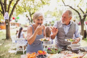 Older couple enjoys a meal at a birthday party