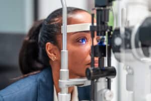 Patient undergoing a slit-lamp eye examination during a glaucoma screening.